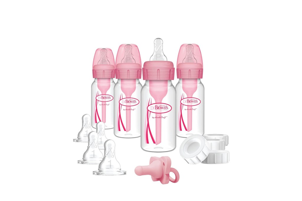 A group of baby bottles with pink caps
