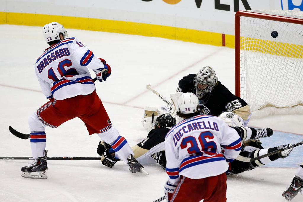 New York Rangers' Derick Brassard (16) puts the puck past Pittsburgh Penguins goalie Marc-Andre Fleury (29) and Robert Bortuzzo (41) for the game-winning goal in the first overtime period of Game 1 of a second-round NHL hockey playoff series in Pittsburgh, Friday, May 2, 2014. The Rangers won 3-2. 