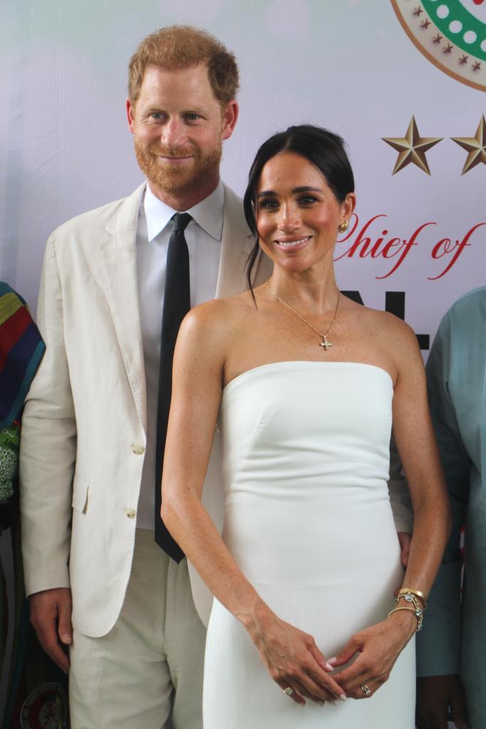 Prince Harry smiling with Meghan Markle. 