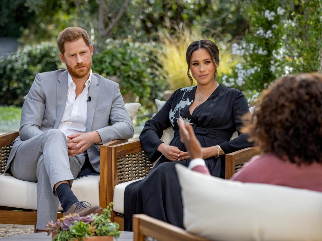 Prince Harry and Meghan, Duchess of Sussex, sitting in chairs during interview with Oprah Winfrey