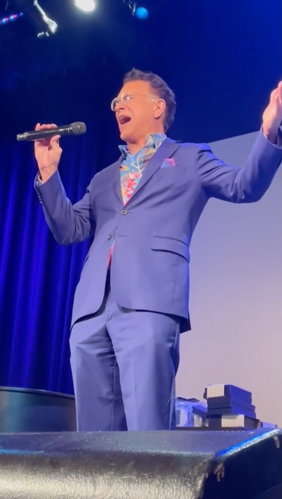 Broadway Star Brian Stokes Mitchell in a suit, holding a microphone, singing 'Impossible Dream' at an event for Governor Kathy Hochul's re-election campaign