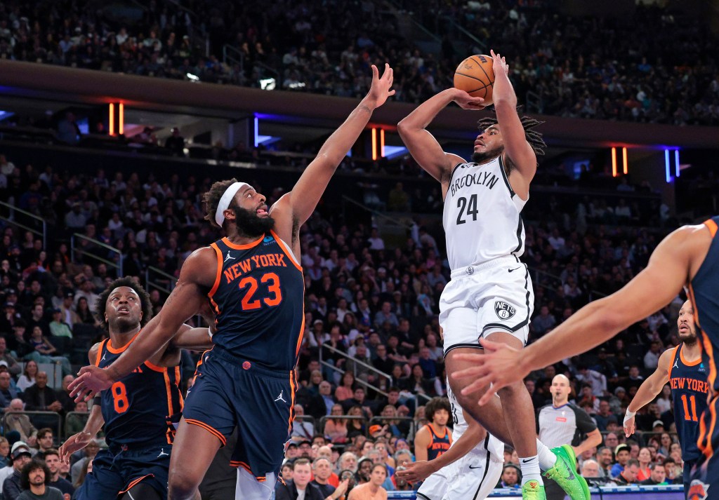 Cam Thomas #24 goes up for a shot as New York Knicks center Mitchell Robinson #23 defends during the fourth quarter. The New York Knicks defeated the Brooklyn Nets 111-107.