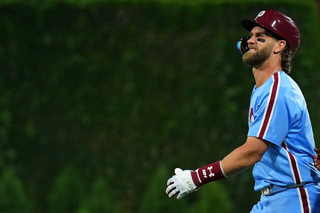 Bryce Harper winces in pain during the Phillies' loss to the Marlins on June 27, 2024.