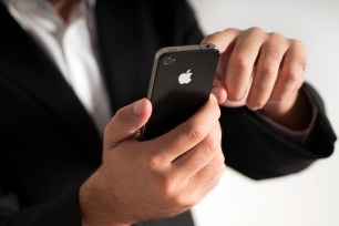 Businessman using a 4th generation Apple iPhone