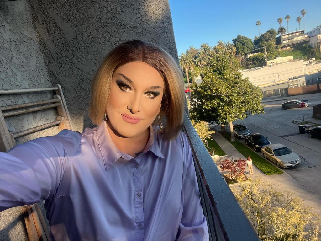 California local official and drag queen Maebe A. Girl taking a selfie while discussing her initiative to remove homophobic U-turn signs in Silver Lake