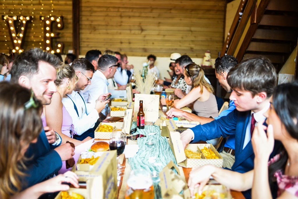 wedding guests eating burgers and fries 