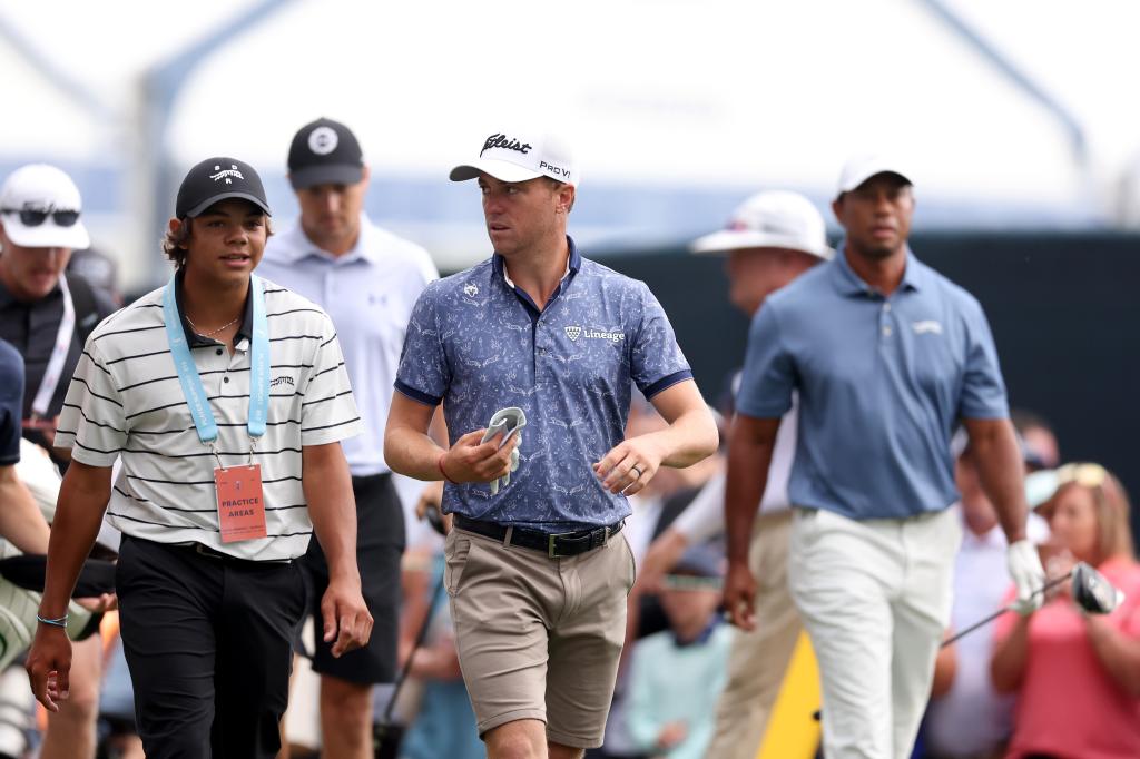 Charlie Woods (l.) with Justin Thomas (c.) and Tiger Woods (r.) on Monday.