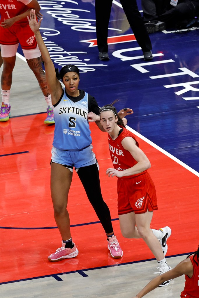 Chicago Sky forward Angel Reese being guarded by Indiana Fever guard Caitlin Clark during a WNBA game at Gainbridge Fieldhouse in Indianapolis, Indiana