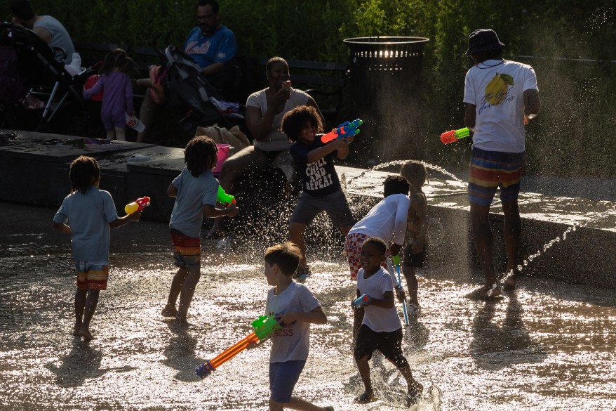 Children play with water guns at a splash pad at LeFrak Center at Lakeside at Prospect Park