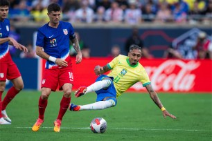 Christian Pulisic, a football player, diving towards the ball