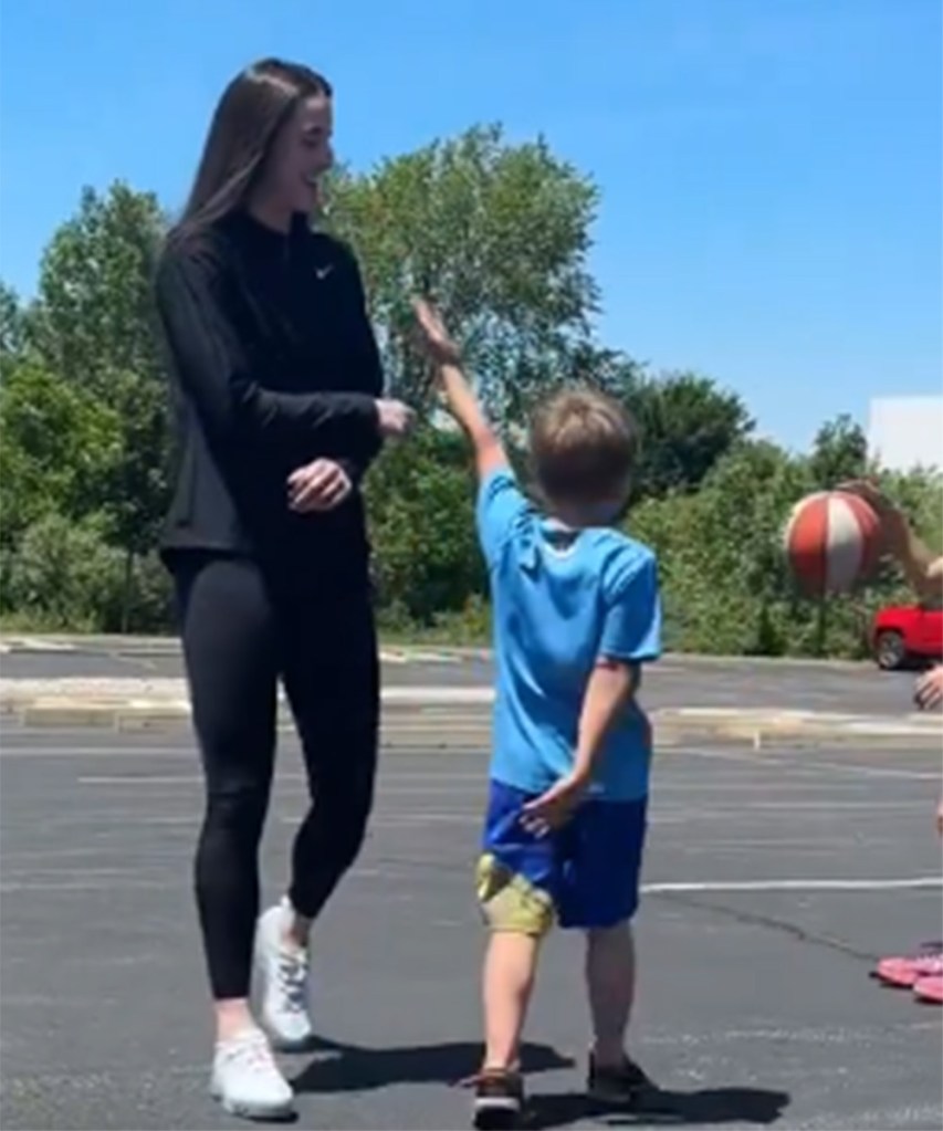Caitlin Clark playing 1-1 with a young fan at a community event in Indiana on June 11, 2024.