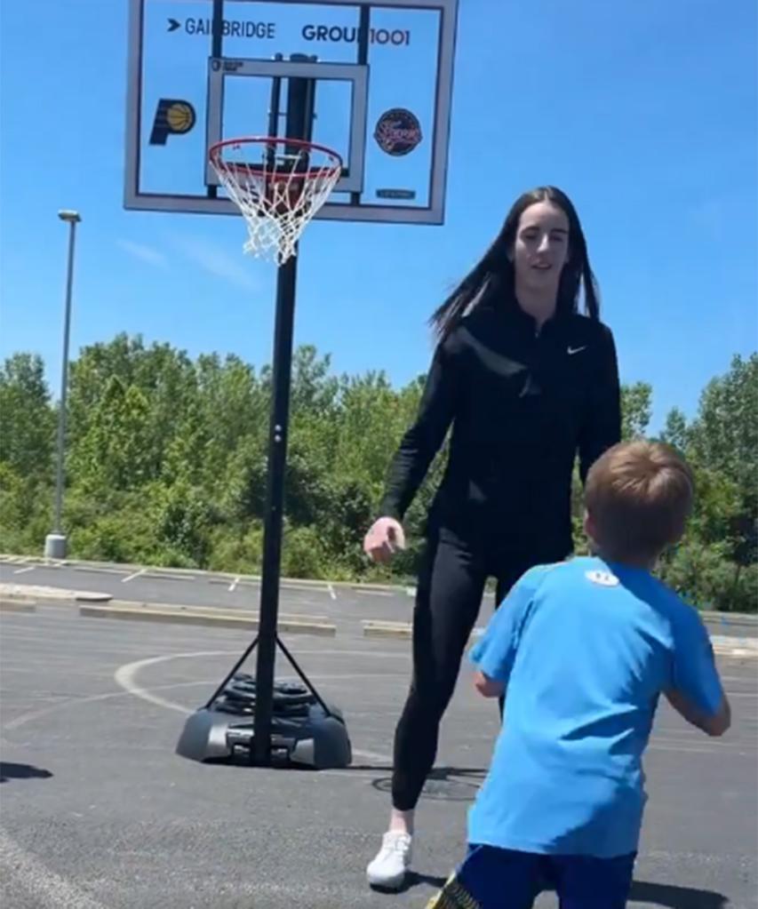 Caitlin Clark playing 1-1 with a young fan at a community event in Indiana on June 11, 2024.