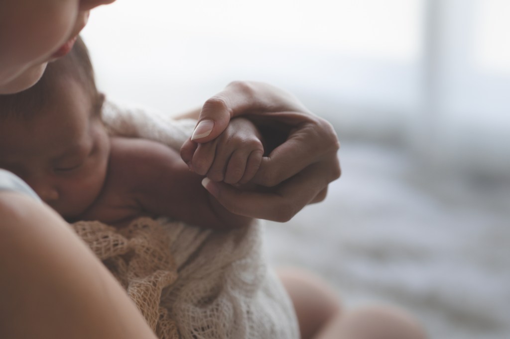 woman holding sleeping baby