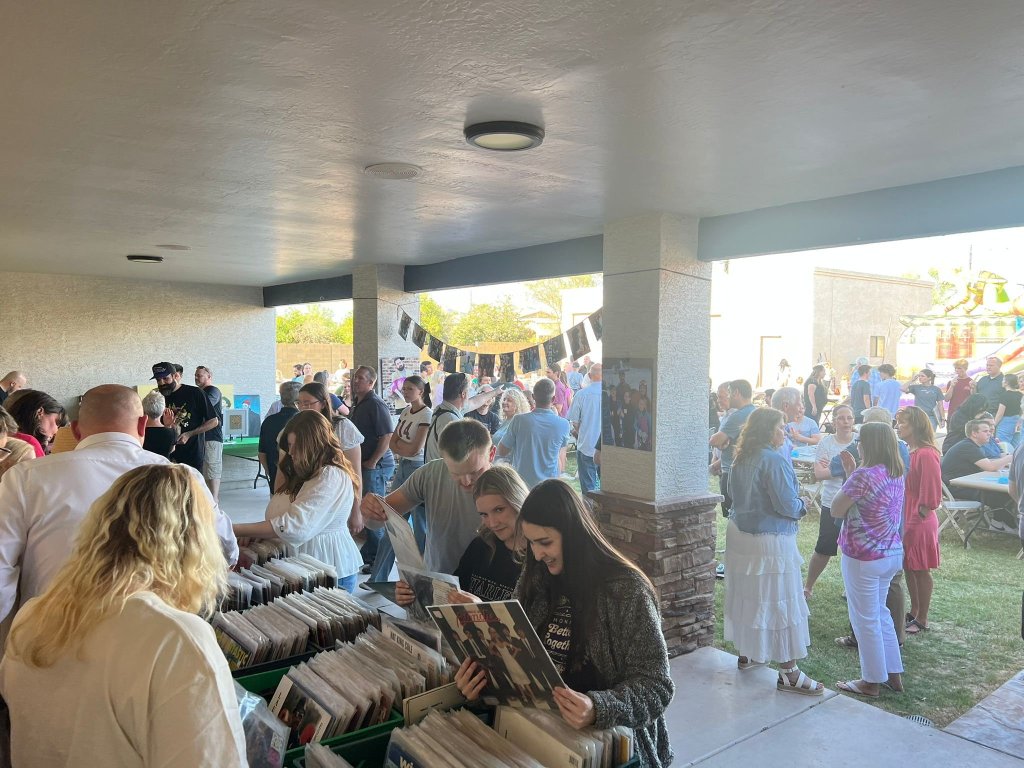 A large group of people gathered at the 'FUNeral' of Brandon Young, featuring a bouncy castle and favorite food, a testament to celebration of life