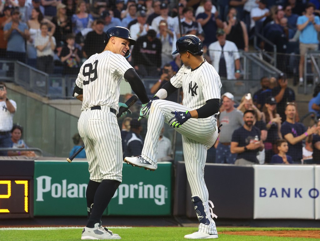 Yankees outfielder Aaron Judge (99) congratulates New York Yankees outfielder Juan Soto (22) on his 2-run home run during the third inning.