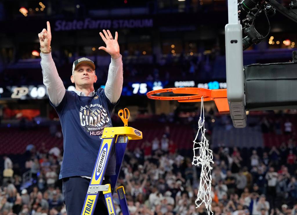 Connecticut Huskies head coach Dan Hurley cuts the basketball net winning the Men's NCAA national championship game against the Purdue Boilermakers at State Farm Stadium in Glendale on April 8, 2024.