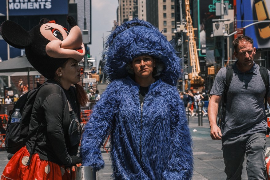characters in Times Square with headpieces off 