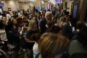 Crowds of people rush gates and wait on trains that have been delayed or cancelled at NJ Transit at Penn Station in NYC.