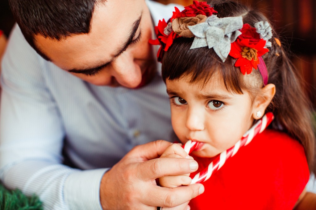 Dad takes a candy away from his little daughter