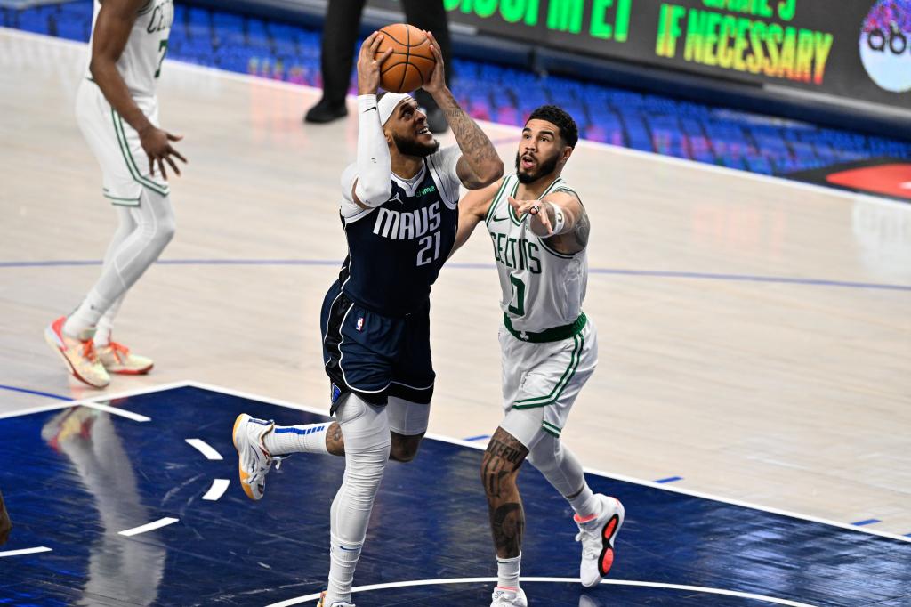 Dallas Mavericks center Daniel Gafford (21) drives against Boston Celtics forward Jayson Tatum (0)  during the second half of game four of the 2024 NBA Finals at American Airlines Center.