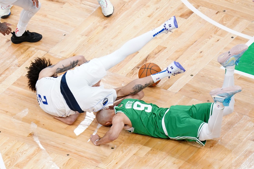 Dallas Mavericks center Dereck Lively II (2) collides with Boston Celtics guard Derrick White (9) in the second quarter during game five of the 2024 NBA Finals at TD Garden. 