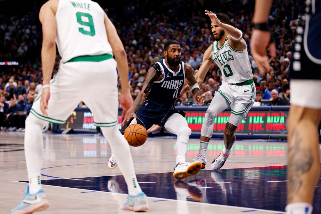 Dallas Mavericks guard Kyrie Irving (11) drives to the basket against Boston Celtics forward Jayson Tatum (0) during the third quarter during game four of the 2024 NBA Finals at American Airlines Center.