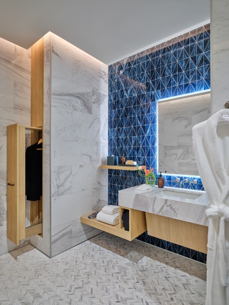 The lounge boasts bathroom and shower stalls outfitted with robes and slippers.