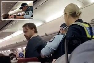 Police officers arresting a man on a Virgin Australia flight at Melbourne Airport