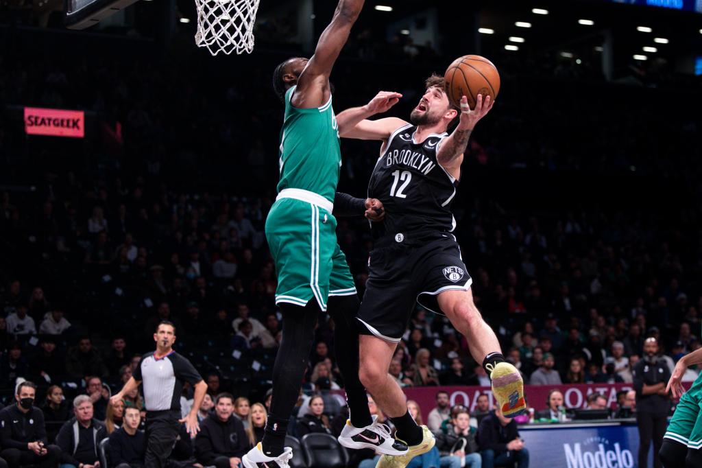 Brooklyn Nets forward Joe Harris (12) driving to the basket while defended by Boston Celtics guard Jaylen Brown (7) at Barclays Center