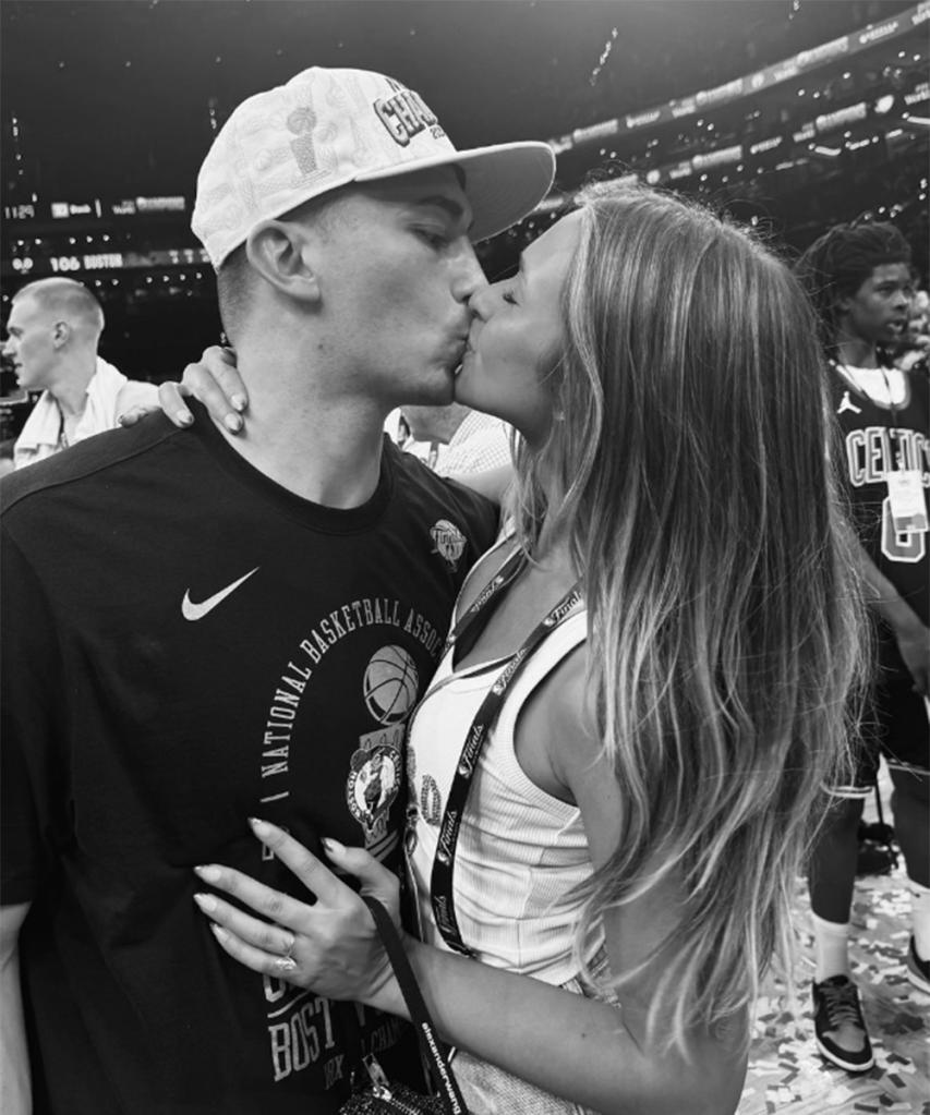 Celtics point guard Payton Pritchard and his fiancée Emma Macdonald kiss on the court at TD Garden after the Celtics' win over the Mavericks in Game 5 of the NBA Finals at TD Garden on June 17, 2024.