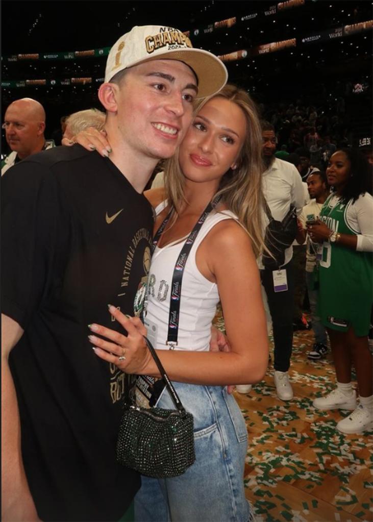 Celtics point guard Payton Pritchard and his fiancée Emma Macdonald on the court at TD Garden after the Celtics' win over the Mavericks in Game 5 of the NBA Finals at TD Garden on June 17, 2024.  