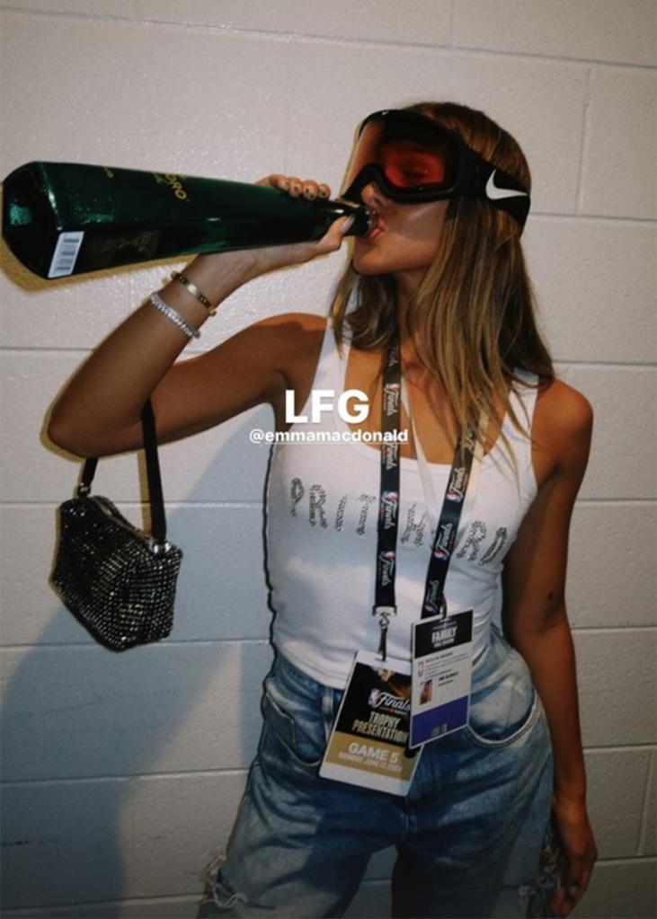 Celtics point guard Payton Pritchard's fiancée Emma Macdonald chugs tequila after Boston beat the Mavericks in Game 5 of the NBA Finals at TD Garden on June 17, 2024.