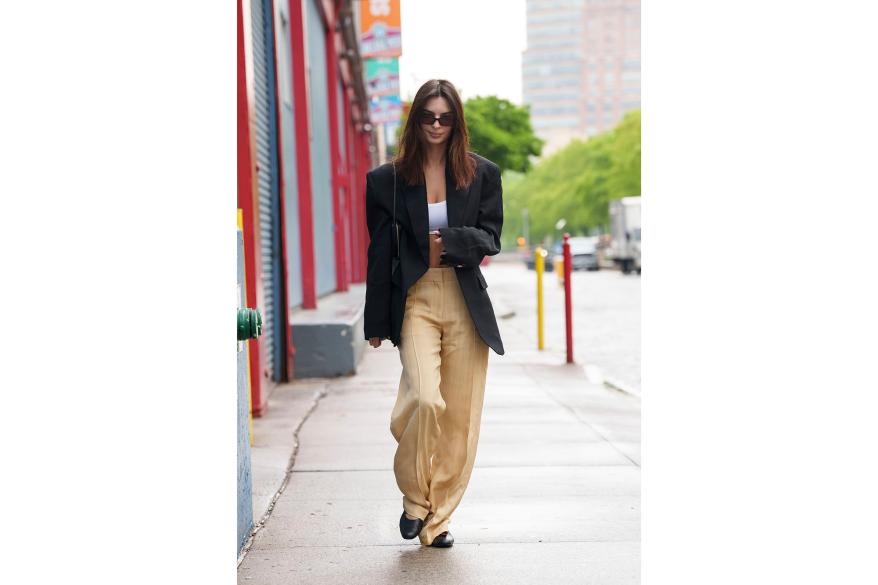 Emilie Ratajkowski walking down the street in yellow pants