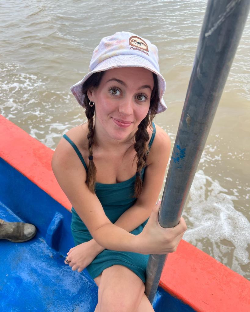 Jordon Hudson, a former cheerleader, in a hat on a boat during an outdoor adventure