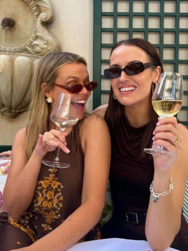 Podcast co-hosts Michelle and Zara holding wine glasses while discussing topic of turning 30