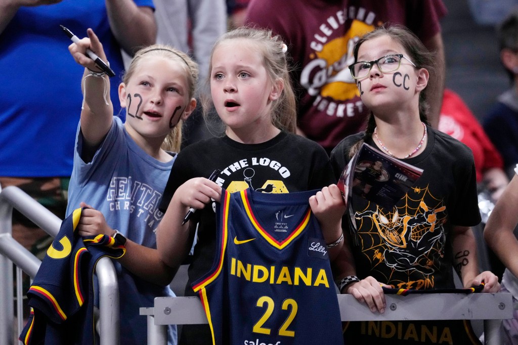 Fans watch Indiana Fever guard Caitlin Clark warm up for the team's WNBA basketball game against the New York Liberty on Thursday, May 16, 2024.