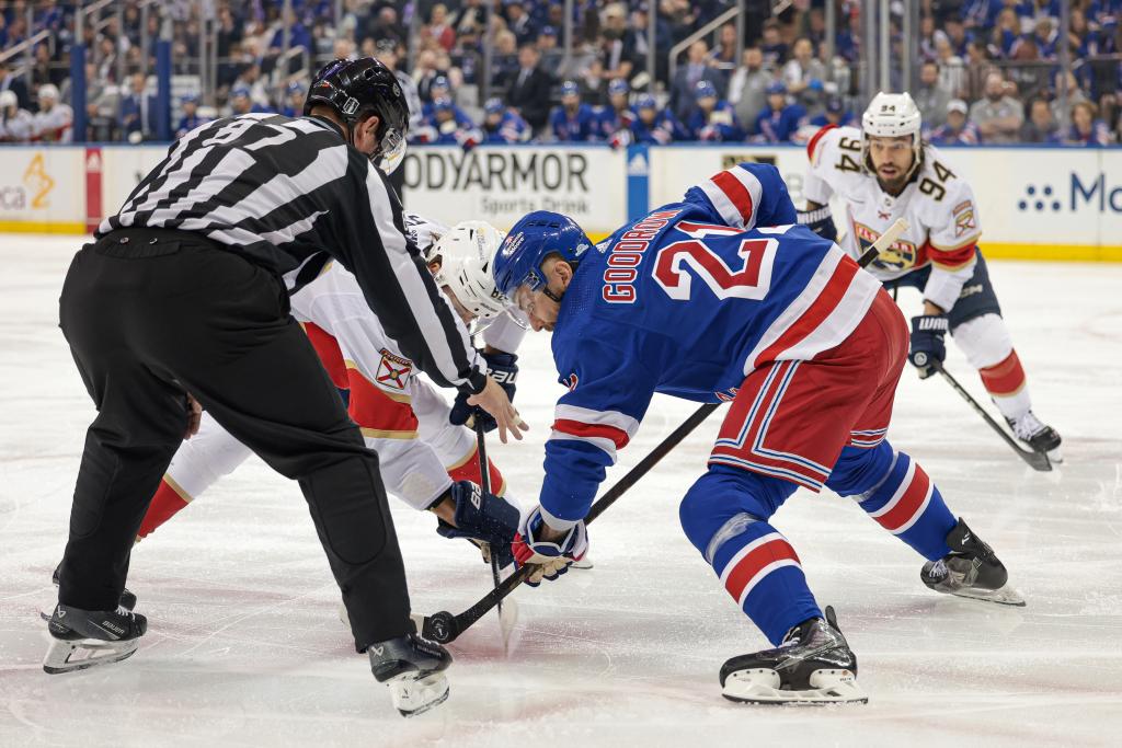 Panthers center Kevin Stenlund (82) faces off against New York Rangers center Barclay Goodrow.