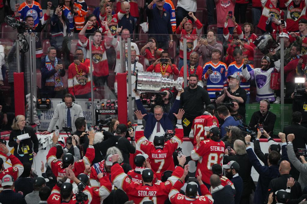 Florida Panthers head coach Paul Maurice hoists the Stanley Cup after defeating Edmonton Oilers in game seven of the 2024 Stanley Cup Final.