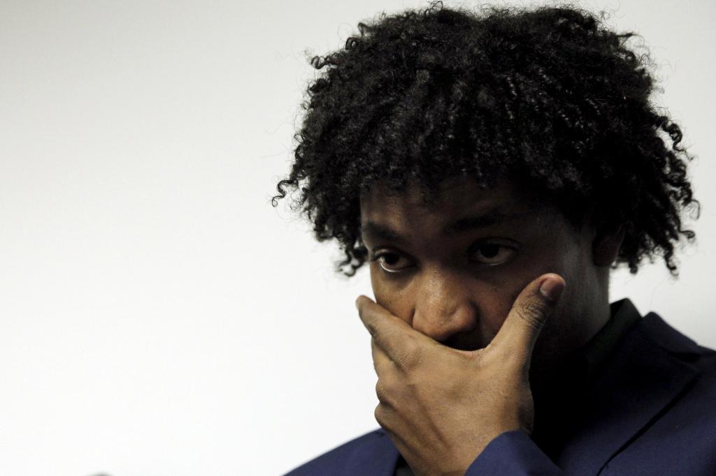 Former Major League Baseball pitcher Jenrry Mejia pauses during a news conference with his hand over his mouth