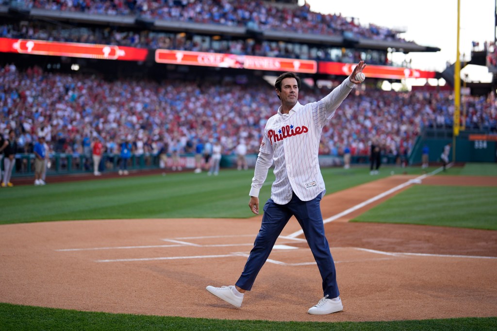 Cole Hamels waves after a ceremony honoring his retirement before a baseball game between the Philadelphia Phillies.