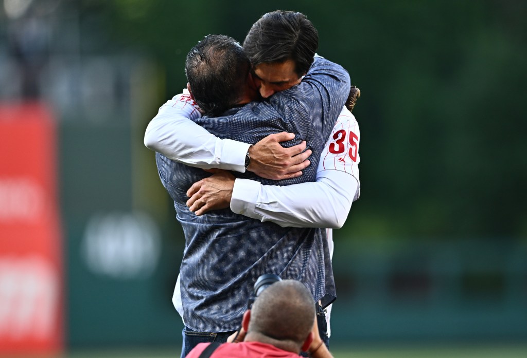 Philadelphia Phillies pitcher Cole Hamels embraces former catcher Carlos Ruiz after throwing a ceremonial first pitch before the game against the Arizona Diamondbacks at Citizens Bank Park.
