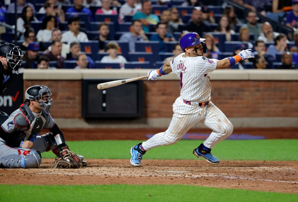 Francisco Alvarez grounds into a fielders choice allowing Starling Marte #6 of the New York Mets to score during the 7th inning against the Marlins.