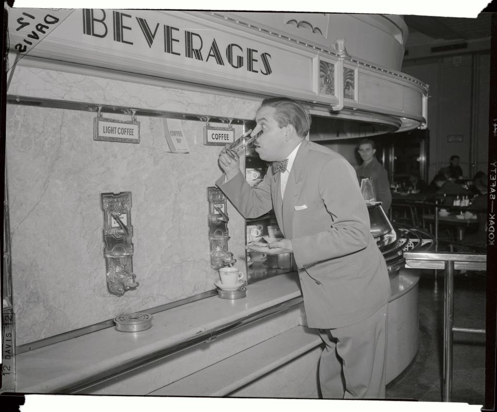 A customer apparently can't believe his eyes over the inexpensive coffee price at this automat.