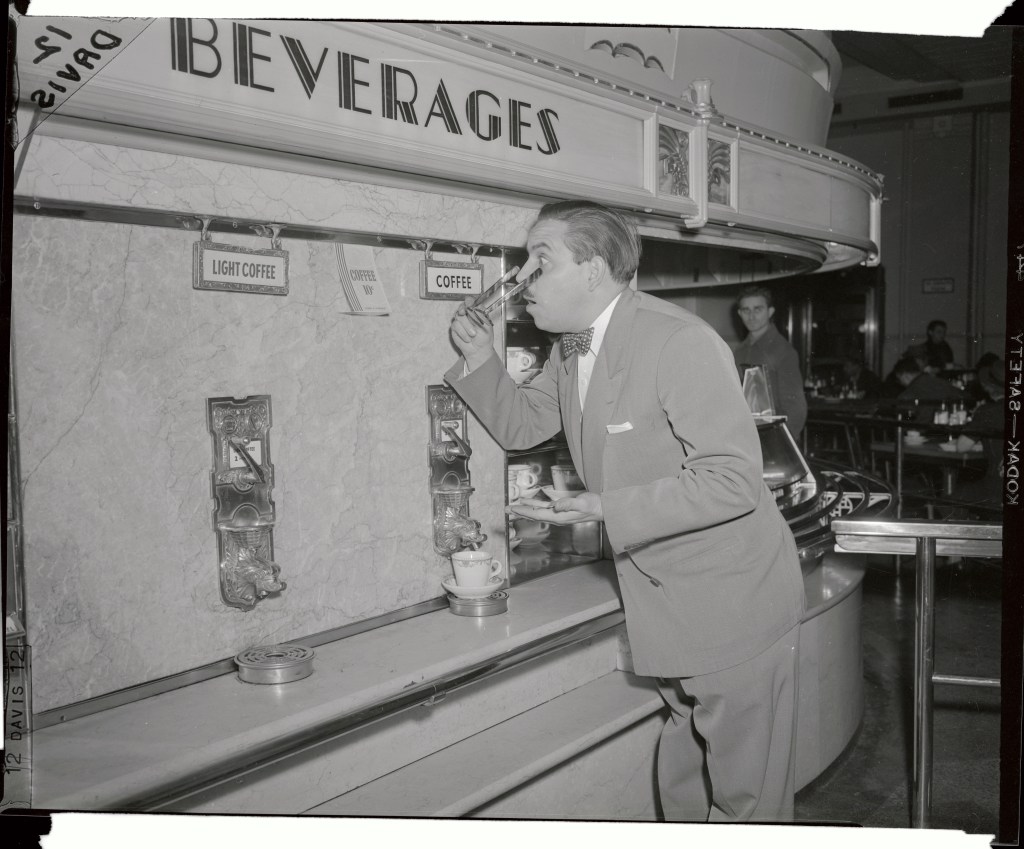 A customer apparently can't believe his eyes over the inexpensive coffee price at this automat.