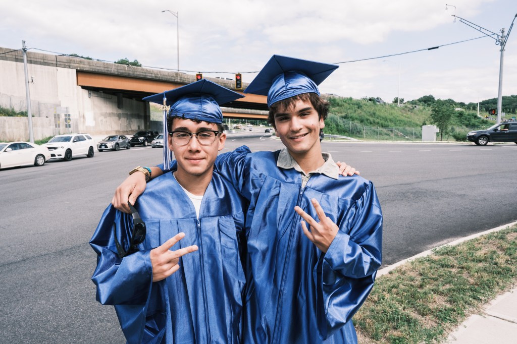 Gustavo Toledo, 18, left, and Juliano Barnes, 18, right, attend the Newtown High School graduation but were not present during the 2012 attack.