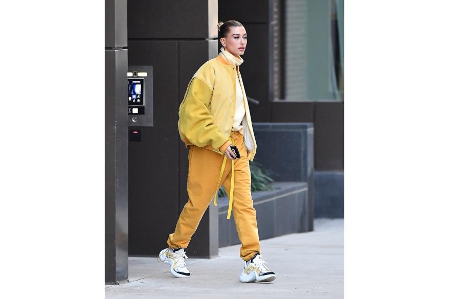 Hailey Bieber walking outside in yellow sweat set