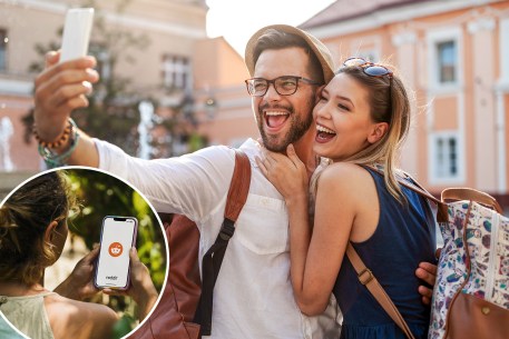 A joyful tourist couple in love, taking a selfie while laughing on their vacation