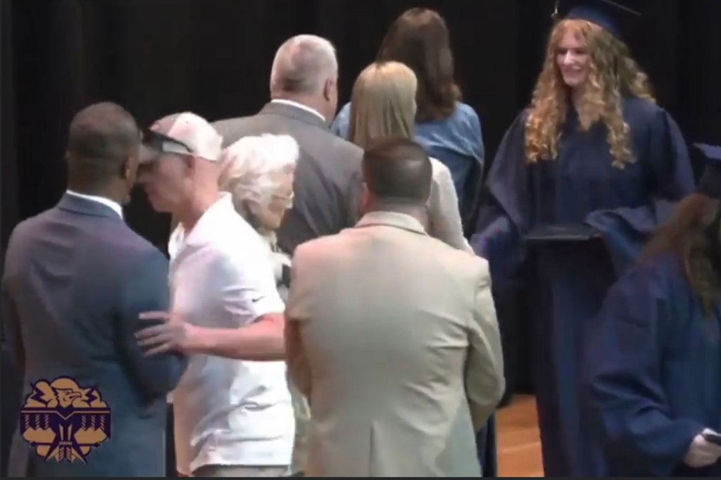 During the ceremony inside the school's gymnasium, Eddy rushed the stage and pushed the administrator out of the way before his daughter shook Briggs' hand.