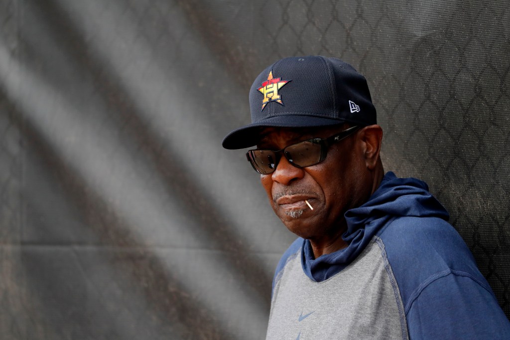 Houston Astros manager Dusty Baker leans against at fence during spring training baseball practice Thursday, Feb. 13, 2020, in West Palm Beach, Fla.