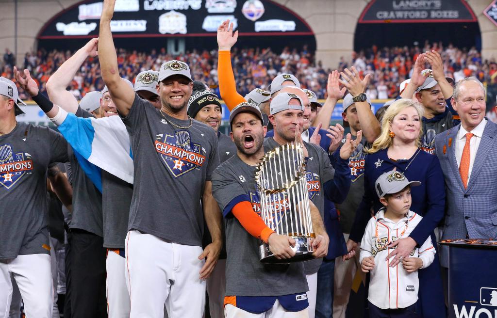 Houston Astros second baseman Jose Altuve holding the 2022 World Series trophy after victory against the Philadelphia Phillies at Minute Maid Park